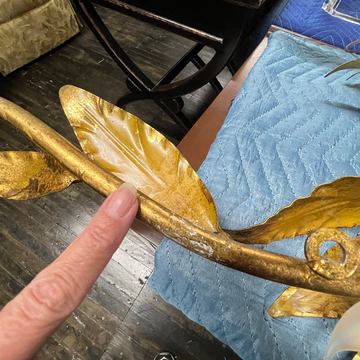 Stunning large gilded wall sconce by Hans Kogl. It has seven arms that have gilded leaves on branches.  Lights are hidden behind certain leaves.  Hollywood Regency Style.  Mid-century corded sconce.