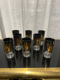 A wonderful set of Fred Press signed mid-century celestial/atomic burst 22-karat gold & black highball glasses. The glasses feature the celestial design; bright bold stars with 22-karat gold and the atomic starburst on one side and a sun/moon eclipse on the other side.  This set appears to never have been used.  Chicago, IL Studio Sonja Milan