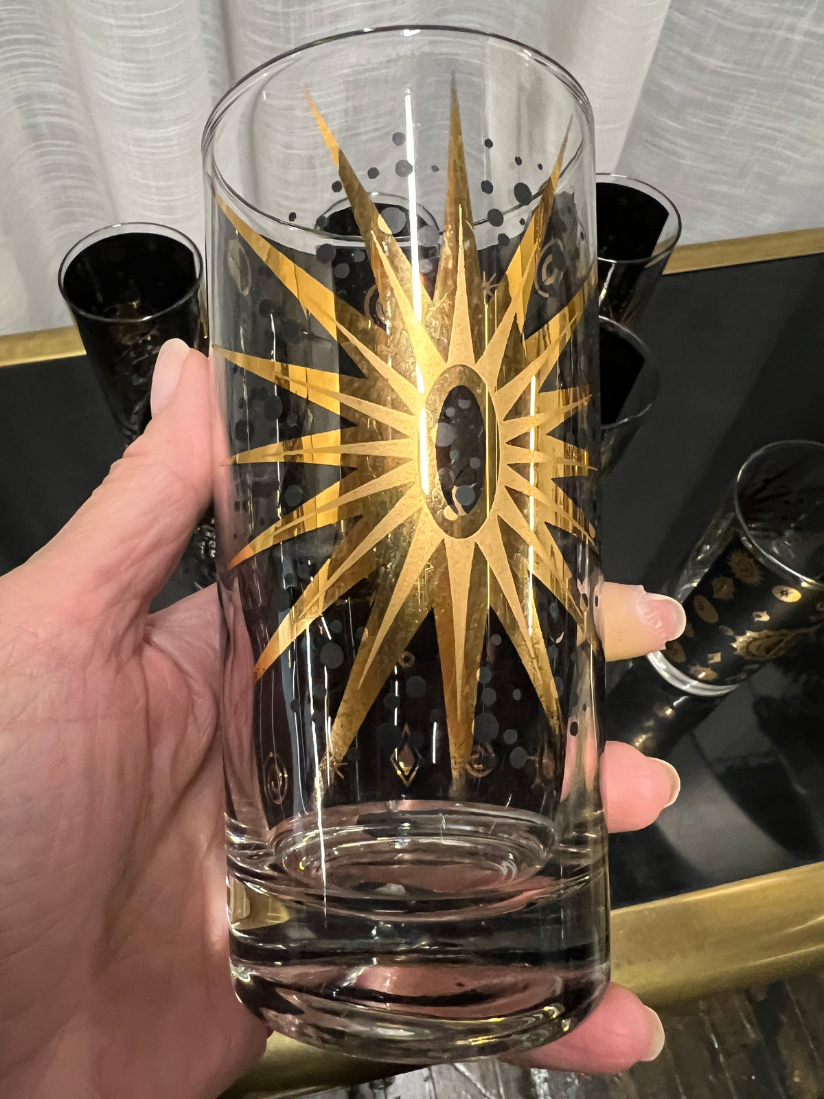 A wonderful set of Fred Press signed mid-century celestial/atomic burst 22-karat gold & black highball glasses. The glasses feature the celestial design; bright bold stars with 22-karat gold and the atomic starburst on one side and a sun/moon eclipse on the other side.  This set appears to never have been used.  Chicago, IL Studio Sonja Milan