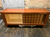 A walnut console cabinet by Berman Rosetti. The piece has 2 doors that slide open to reveal storage inside (one adjustable shelf on either side).  Chicago