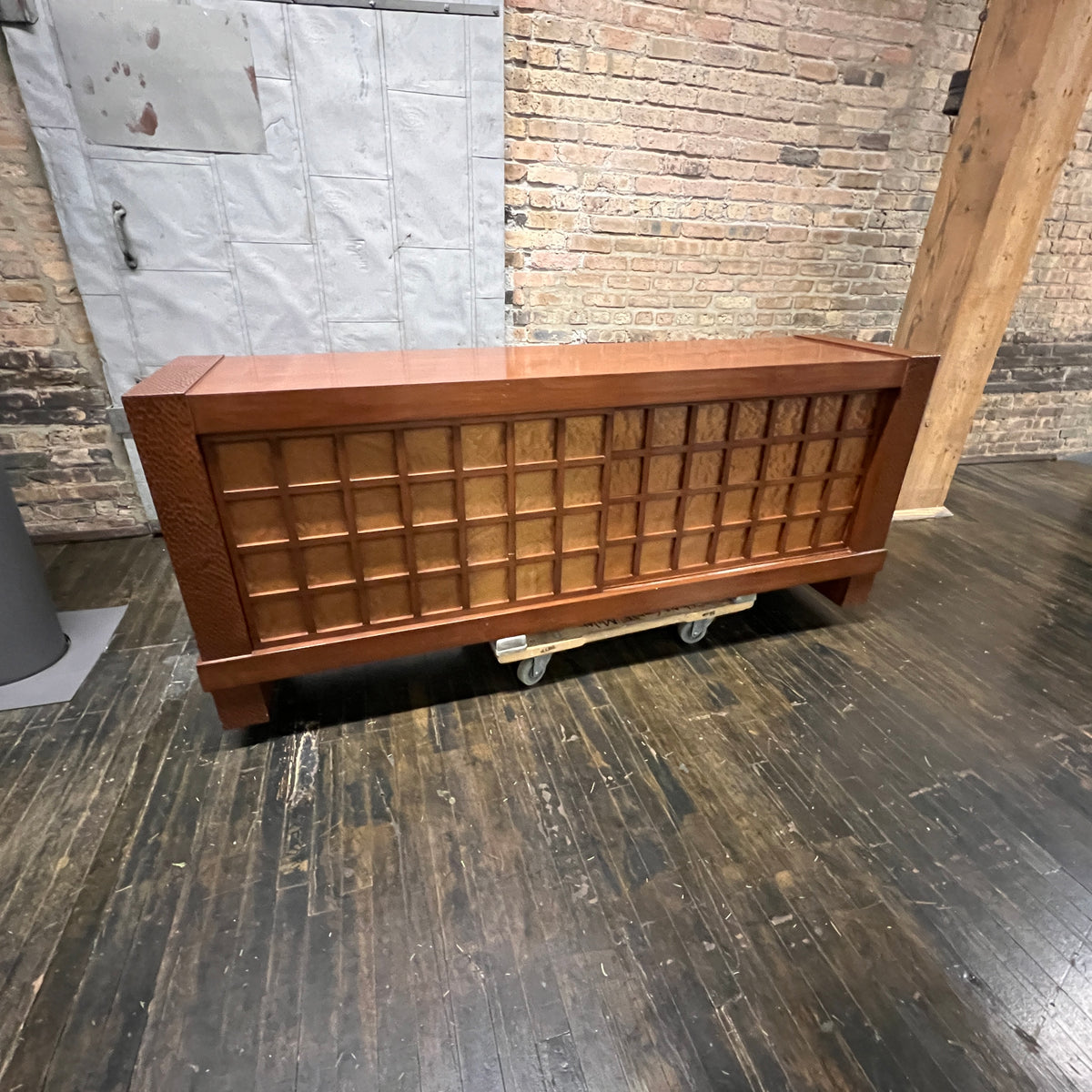 A walnut console cabinet by Berman Rosetti. The piece has 2 doors that slide open to reveal storage inside (one adjustable shelf on either side).  Chicago