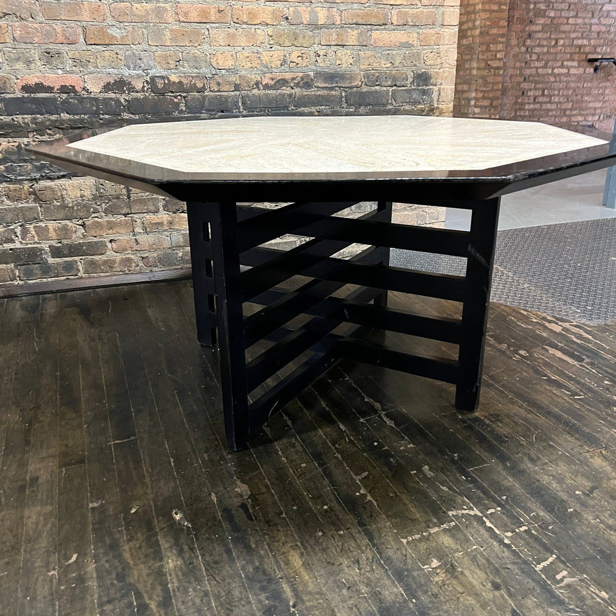 Bold octagonal table by Harvey Probber. Ebonized cross form base and a parquet like travertine top that is inset with an ebonized wood border. Chicago, IL, Studio Sonja Milan