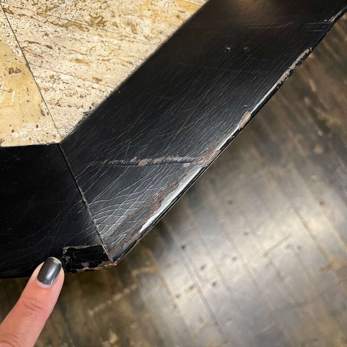 Bold octagonal table by Harvey Probber. Ebonized cross form base and a parquet like travertine top that is inset with an ebonized wood border. Chicago, IL, Studio Sonja Milan