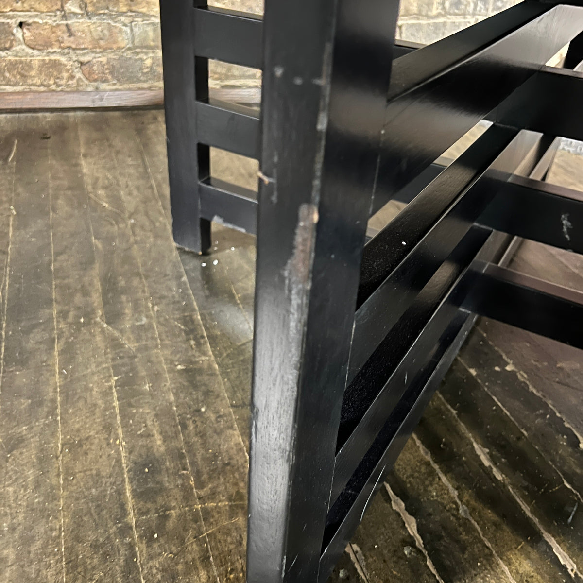 Bold octagonal table by Harvey Probber. Ebonized cross form base and a parquet like travertine top that is inset with an ebonized wood border. Chicago, IL, Studio Sonja Milan