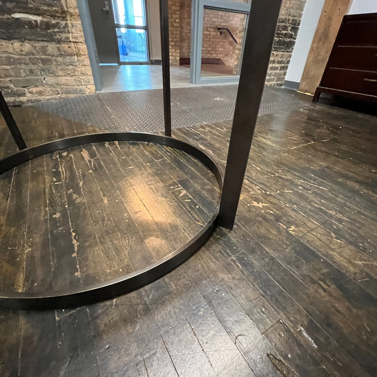 Stunning and impressive solid bronze dining table on an open pedestal base with red lacquer table top.  78" round.  Chicago, IL Studio Sonja Milan
