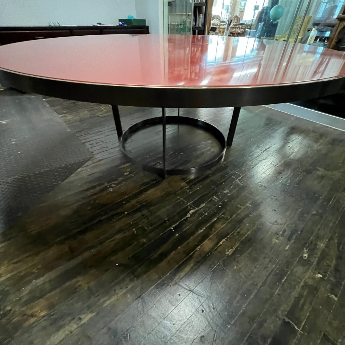 Stunning and impressive solid bronze dining table on an open pedestal base with red lacquer table top.  78" round.  Chicago, IL Studio Sonja Milan