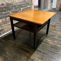 Lovely mid-century modern occasional table circa 1950.  Designed by Edward Wormley for Dunbar Furniture.  This walnut table has a lacquered wood base with leather trim near the feet.  The table is in vintage condition.  Studio Sonja Milan, Chicago, IL