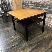 Lovely mid-century modern occasional table circa 1950.  Designed by Edward Wormley for Dunbar Furniture.  This walnut table has a lacquered wood base with leather trim near the feet.  The table is in vintage condition.  Studio Sonja Milan, Chicago, IL