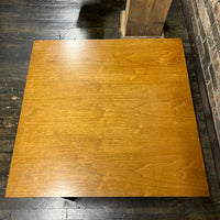 Lovely mid-century modern occasional table circa 1950.  Designed by Edward Wormley for Dunbar Furniture.  This walnut table has a lacquered wood base with leather trim near the feet.  The table is in vintage condition.  Studio Sonja Milan, Chicago, IL