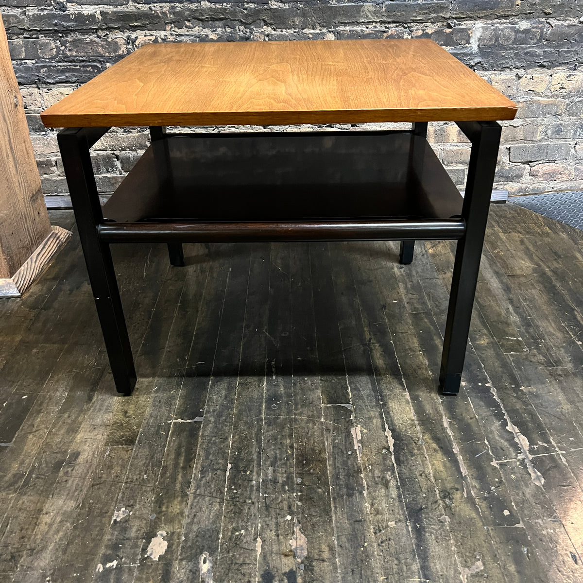 Lovely mid-century modern occasional table circa 1950.  Designed by Edward Wormley for Dunbar Furniture.  This walnut table has a lacquered wood base with leather trim near the feet.  The table is in vintage condition.  Studio Sonja Milan, Chicago, IL