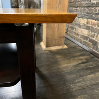 Lovely mid-century modern occasional table circa 1950.  Designed by Edward Wormley for Dunbar Furniture.  This walnut table has a lacquered wood base with leather trim near the feet.  The table is in vintage condition.  Studio Sonja Milan, Chicago, IL