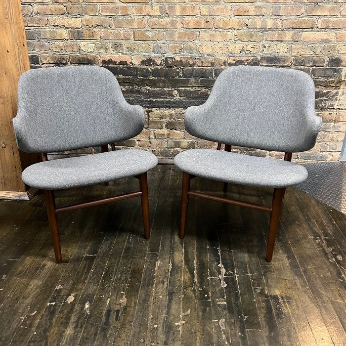 A pair of shell chairs with wood base and gray upholstery. Unmarked. Kofod-Larsen 