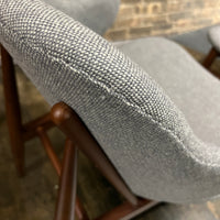 A pair of shell chairs with wood base and gray upholstery. Unmarked. Kofod-Larsen 