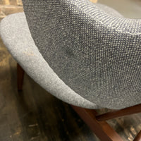 A pair of shell chairs with wood base and gray upholstery. Unmarked. Kofod-Larsen 