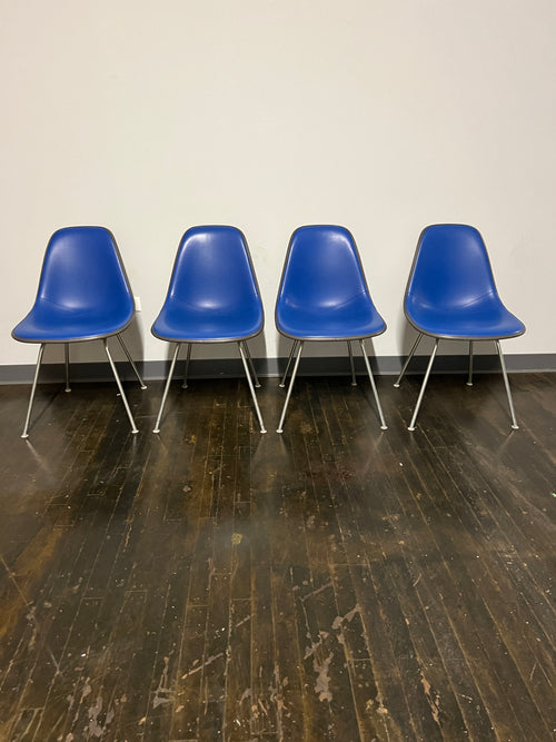 Set of 4 gently used Eames vinyl DSX chairs in electric blue. Originally designed by Charles and Ray Eames in the 1950s. 