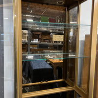 Lovely brass and glass vitrine by Mastercraft. The cabinet features 4 doors and several adjustable glass shelves. The inside of the cabinet has antique glass.