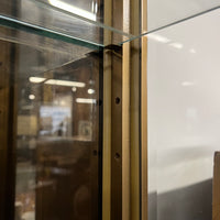 Lovely brass and glass vitrine by Mastercraft. The cabinet features 4 doors and several adjustable glass shelves. The inside of the cabinet has antique glass.