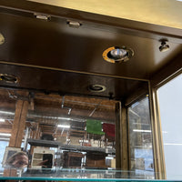 Lovely brass and glass vitrine by Mastercraft. The cabinet features 4 doors and several adjustable glass shelves. The inside of the cabinet has antique glass.