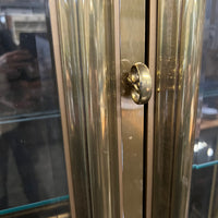 Lovely brass and glass vitrine by Mastercraft. The cabinet features 4 doors and several adjustable glass shelves. The inside of the cabinet has antique glass.