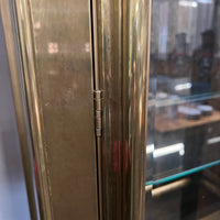 Lovely brass and glass vitrine by Mastercraft. The cabinet features 4 doors and several adjustable glass shelves. The inside of the cabinet has antique glass.