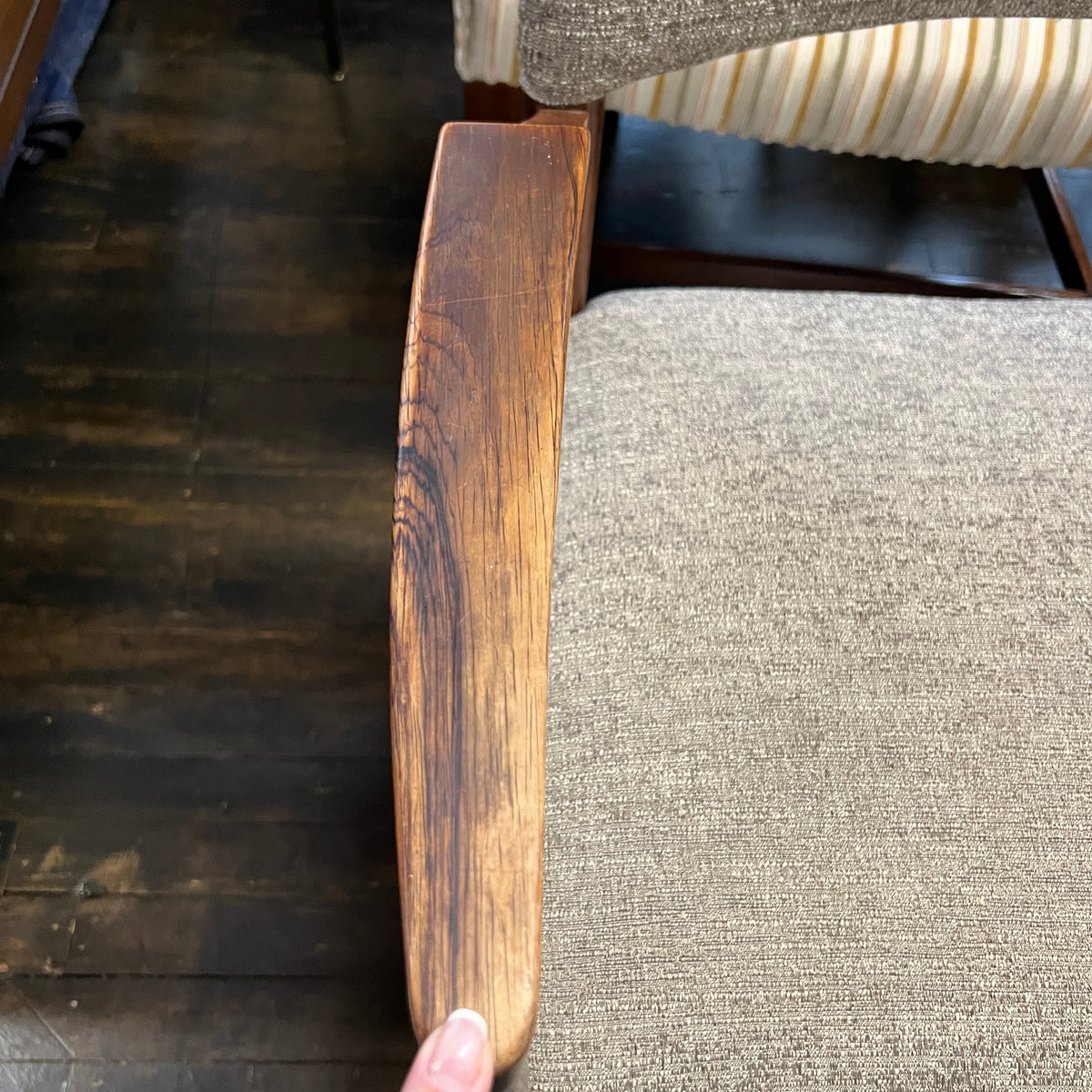 Close-up of a wooden chair arm.
