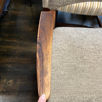 Close-up of a wooden chair arm.