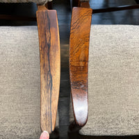 Close-up of chair arms on a textured surface