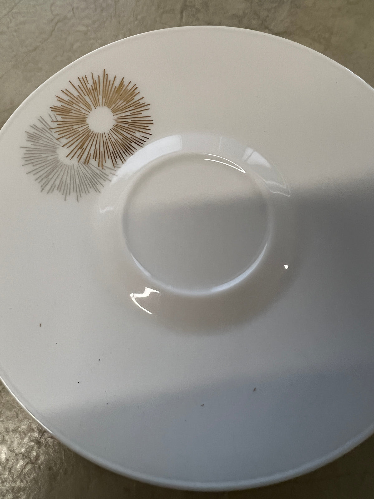 Rosenthal's Sunburst China with gilt silver and gold sunburst detail on a white field. Place settings include: dinner, salad, bread plate, cup and saucer. Gift.