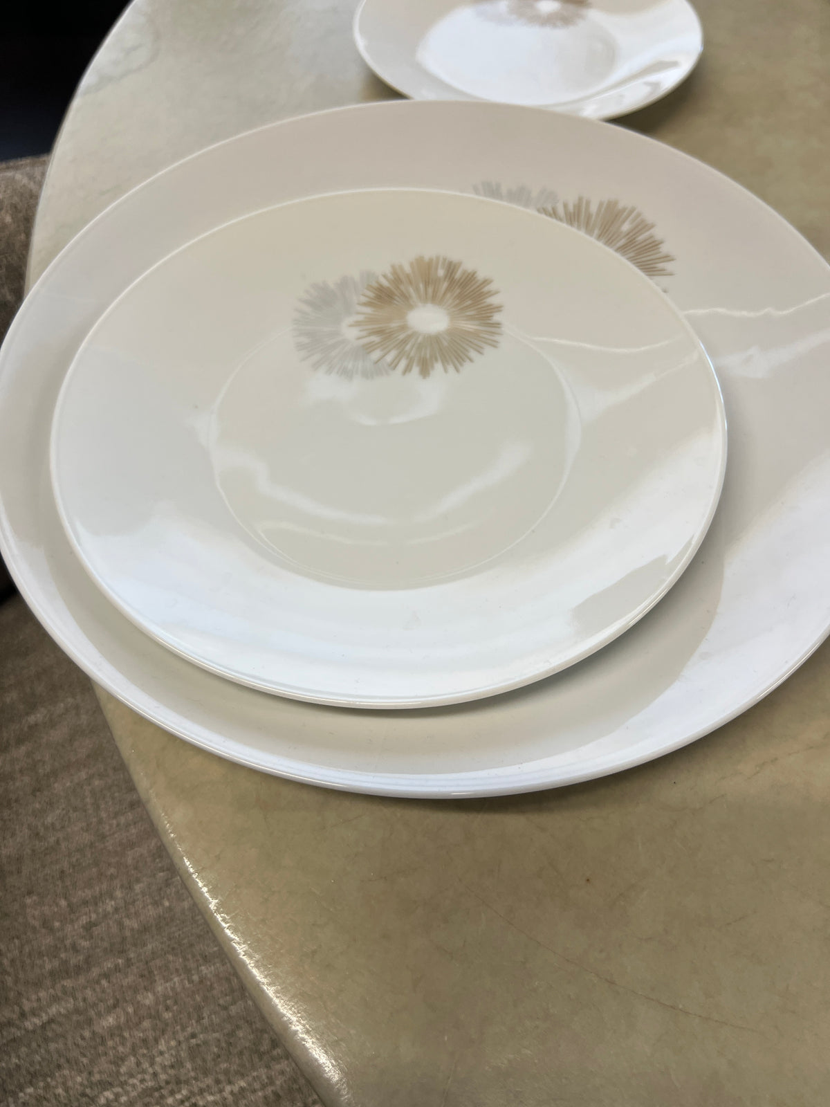 Rosenthal's Sunburst China with gilt silver and gold sunburst detail on a white field. Place settings include: dinner, salad, bread plate, cup and saucer. Gift.