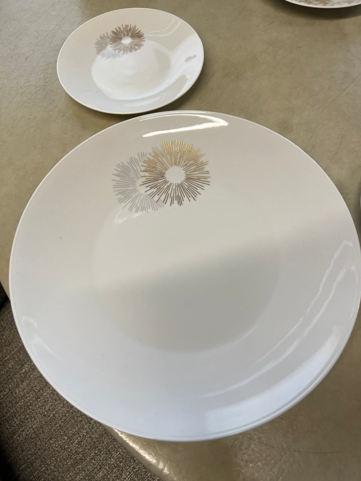 Rosenthal's Sunburst China with gilt silver and gold sunburst detail on a white field. Place settings include: dinner, salad, bread plate, cup and saucer. Gift.