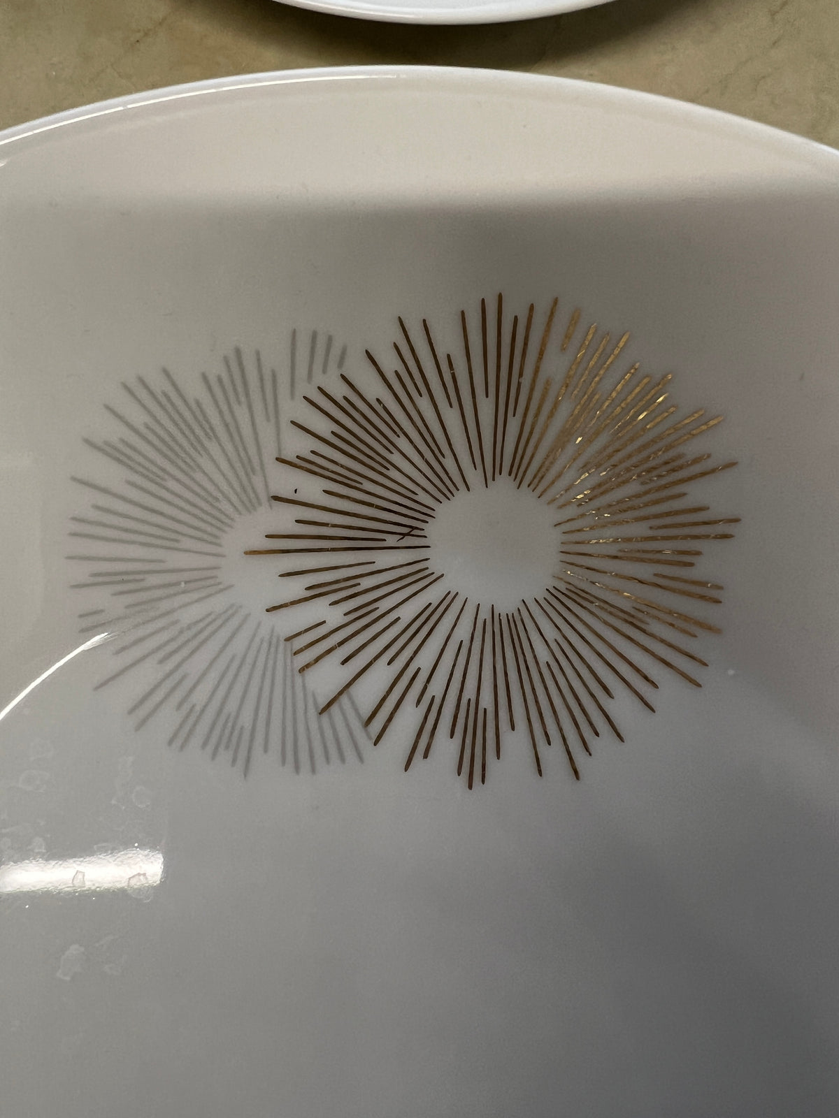 Rosenthal's Sunburst China with gilt silver and gold sunburst detail on a white field. Place settings include: dinner, salad, bread plate, cup and saucer. Gift.