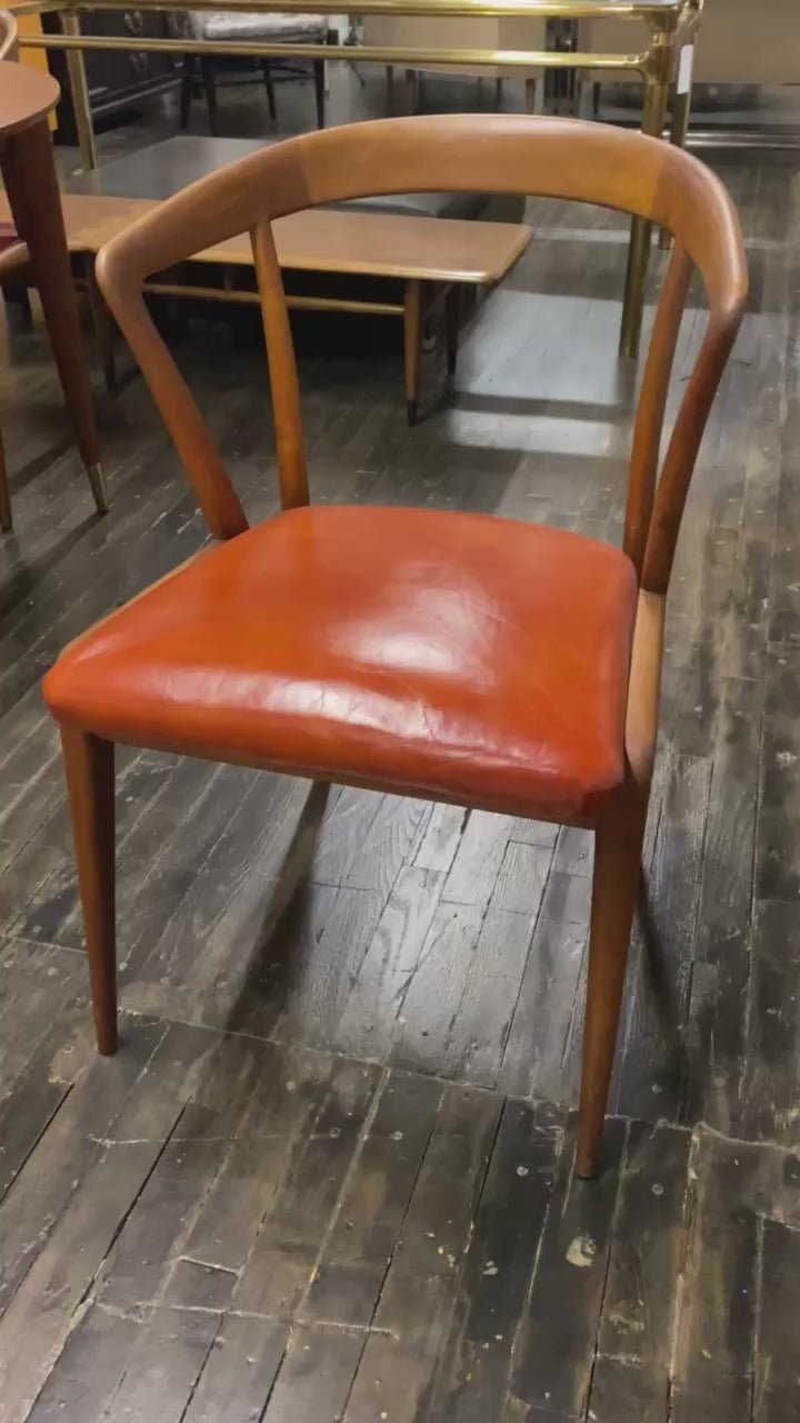 Mid century walnut dining chair by Bertha Schaefer for Singer & Sons, original orange leather upholstered seats. Made in Italy. Set of 8 available.  Chicago