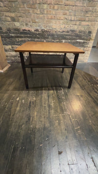 Video of lovely mid-century modern occasional table circa 1950.  Designed by Edward Wormley for Dunbar Furniture.  This walnut table has a lacquered wood base with leather trim near the feet.  The table is in vintage condition.  Studio Sonja Milan, Chicago, IL
