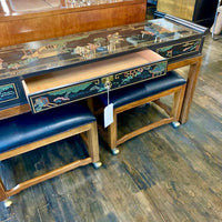 From Drexel's Et Cetera Collection, a lovely console table that has a black lacquer case with one long drawer (perfect place for keys or mail at an entrance) on walnut legs.  Case is painted with a lovely Asian scene (on all 4 sides).  Top of piece has a few scratches (see images).  It is in very good, original, vintage condition.  Has two, newly reupholstered stools on wheels (upholstery is a high-end black vinyl).  Studio Sonja Milan, Chicago