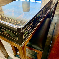 From Drexel's Et Cetera Collection, a lovely console table that has a black lacquer case with one long drawer (perfect place for keys or mail at an entrance) on walnut legs.  Case is painted with a lovely Asian scene (on all 4 sides).  Top of piece has a few scratches (see images).  It is in very good, original, vintage condition.  Has two, newly reupholstered stools on wheels (upholstery is a high-end black vinyl).  Studio Sonja Milan, Chicago