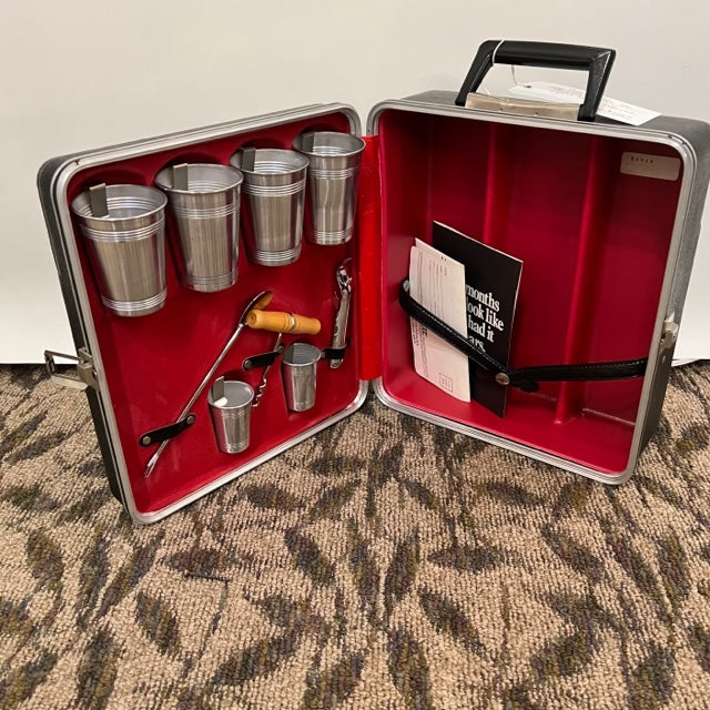vintage traveling bar by Pratt is perfect! The carrying case is made of hard, black plastic.   This piece is best suited for mixed drinks as a standard wine bottle does not fit inside  This item never been used. Wedding Gift, Studio Sonja Milan, Chicago, IL midcentury modern gifts