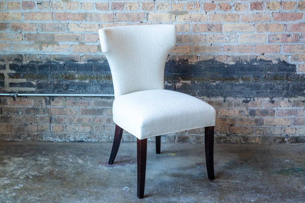 Cream colored upholstered dining chair.
