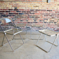 "Plia" clear acrylic folding chairs by Giancarlo Piretti for Castelli