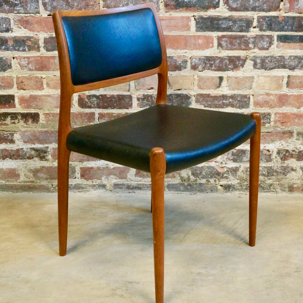 Niels O Moller Teak and black leather dining chairs.