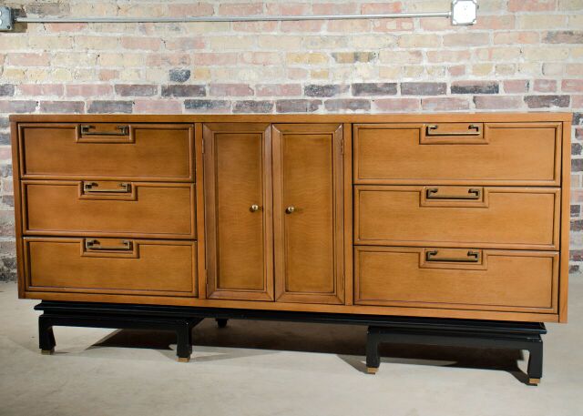 Large mid century modern dresser by American of Martinsville.  Features black lacquer base with brass trim and brass pulls with a bleached mahogany case